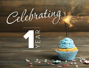 Celebrating one year at Harbourfront Wealth Management. Cupcake with blue icing and sparkler.