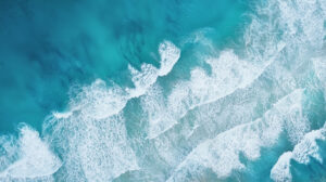 Waves on the beach as a background. Beautiful natural background for Harbourfront Wealth Weekly Tides investment information page.